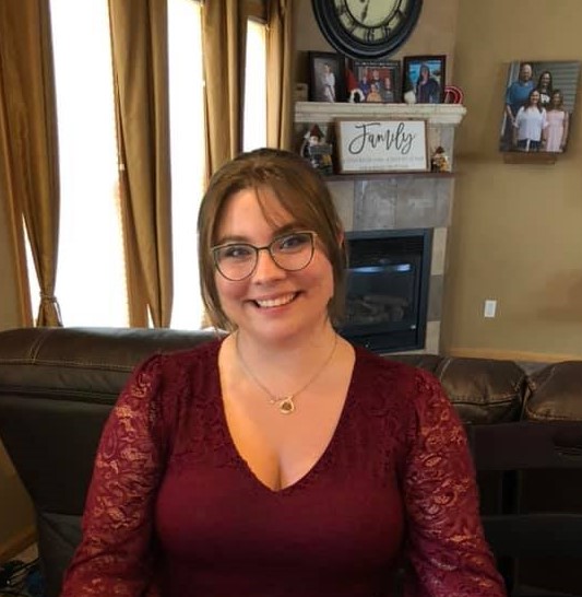 Michelle in a lace blouse, smiling at the camera.
